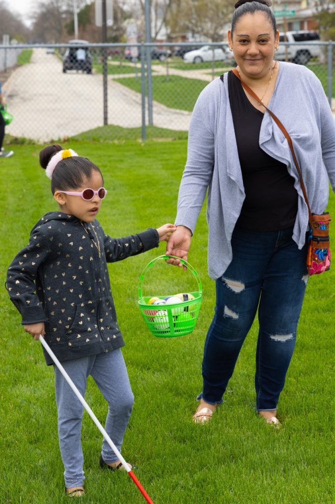 A young girl and her mother are successful in finding beeping Easter eggs at Timber Ridge School.