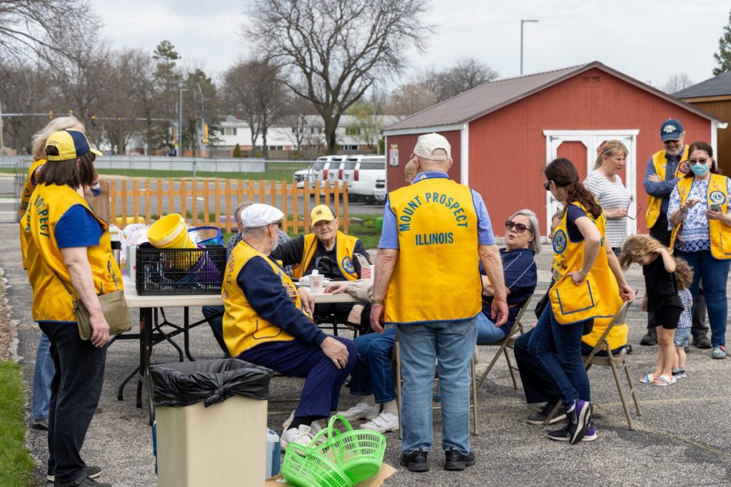 Mount Prospect Lions Club members prepare to hide Easter eggs for visually impaired participants.